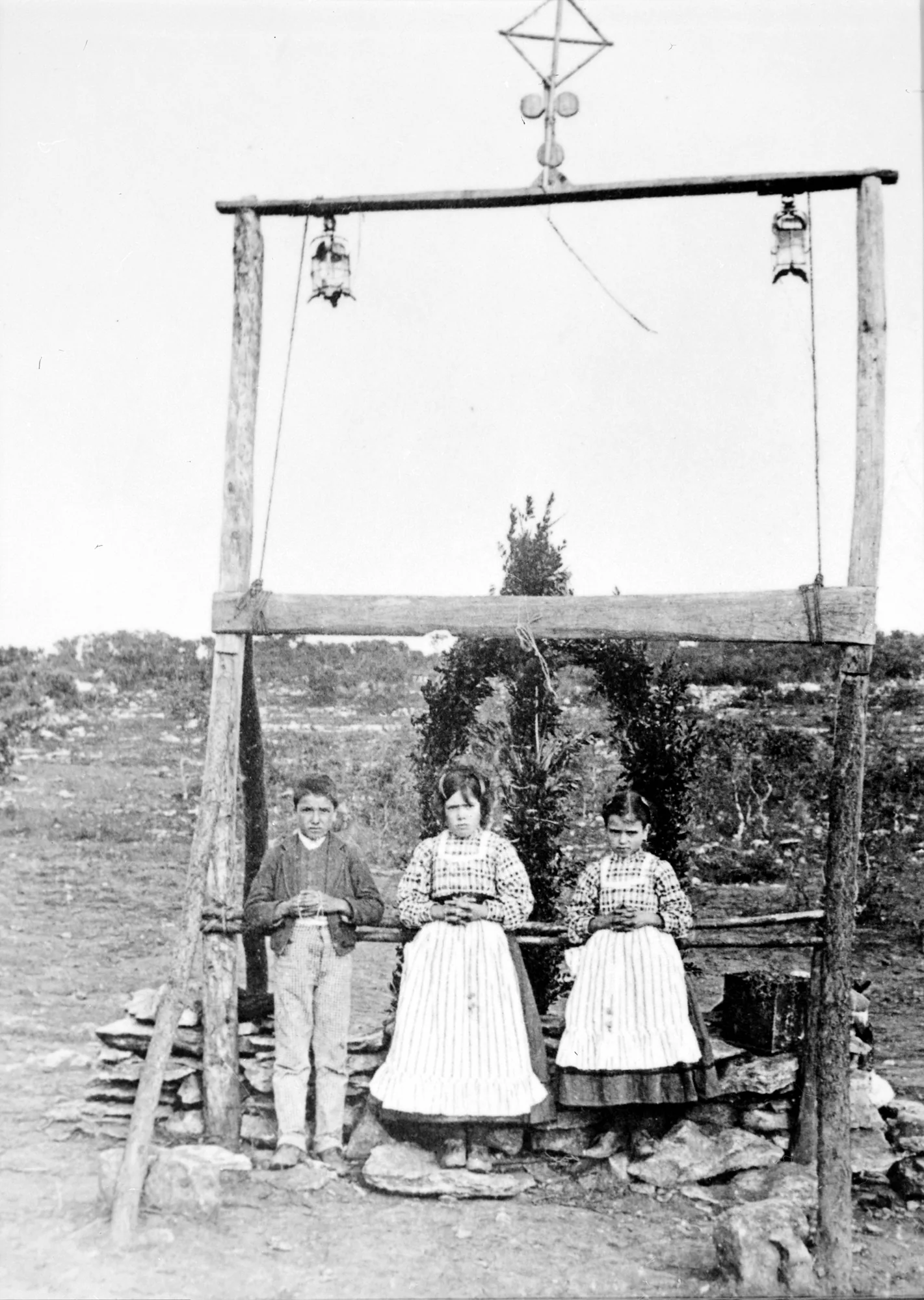 The three seers beneath the rustic arch at the Cova da Iria, 1917: Archive print