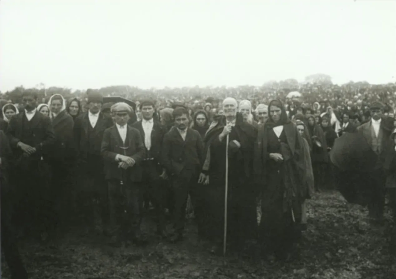 Group standing beside a blind man, Cova da Iria, 13 October 1917: Archive print