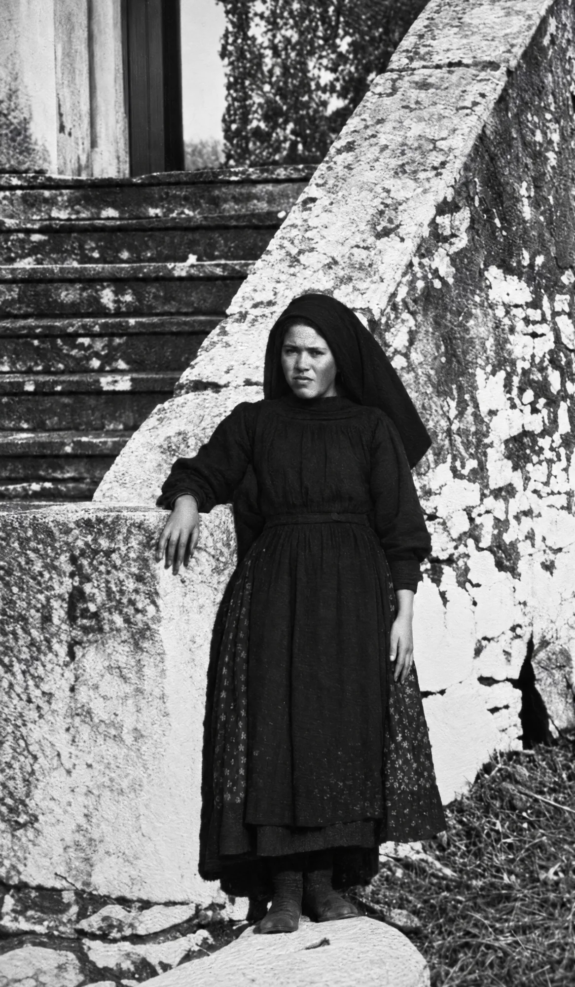 Elderly woman in a black shawl by stone steps: Restored (AI)
